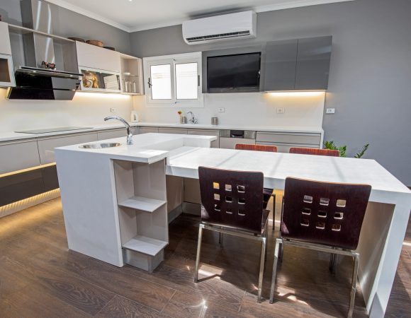 Wall mounted air conditioning unit installed in a modern UK home kitchen living space